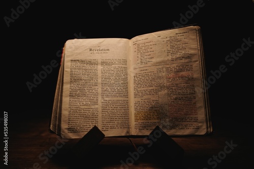 Old Bible book open on the book of Revelation
