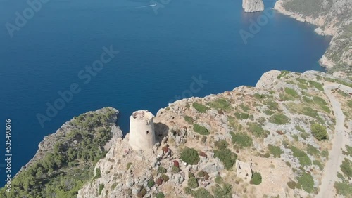 Drone view of the beautiful Albercutx Watchtower surrounded by the sea in  Mallorca, Spain photo
