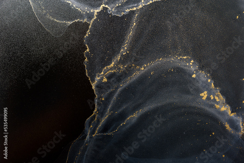 Abstract alcohol ink fluid art background on black. White color clouds with gold
