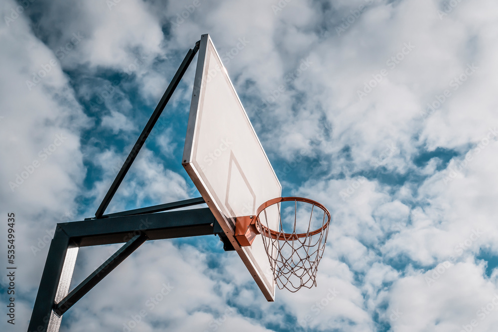 Basketball Backboard and Hoop in front of sky background Basketball Backboard and Hoop in front of sky background
