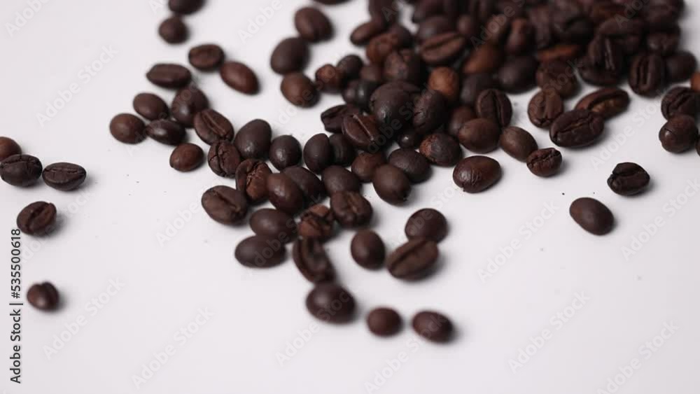 Close-up Roasted coffee beans on wooden spoon at white background. Close-up Roasted coffee beans on wooden spoon at white background.