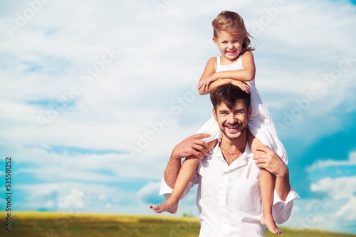 Father with a child in agricultural field background.