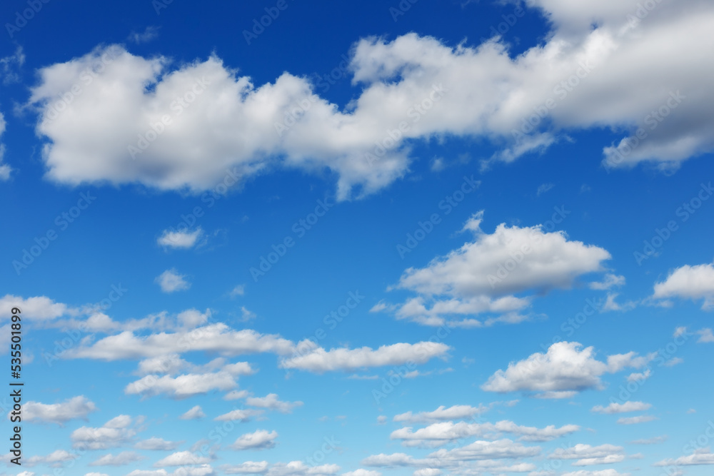 Blue sky natural background. White clouds in the blue sky Blue sky natural background. White clouds in the blue sky