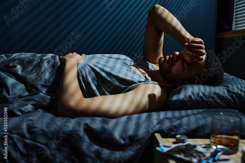 Принти на полотні Young man in trouble staying up all night unable to get asleep while remembering