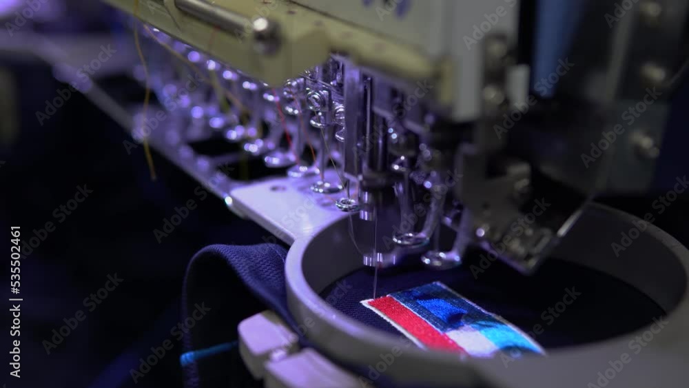custom made wallpaper toronto digitalEmbroidery machine in progress embroidery company logo on uniform in Textile Industry at Garment Manufacturers.
