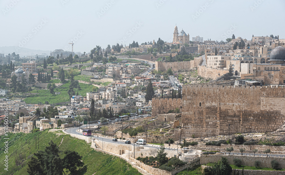 View from above over Jerusalem fortress and wall with the cemetery from Mount of Olives in foreground. Landmark landscape view of this city from Israel.