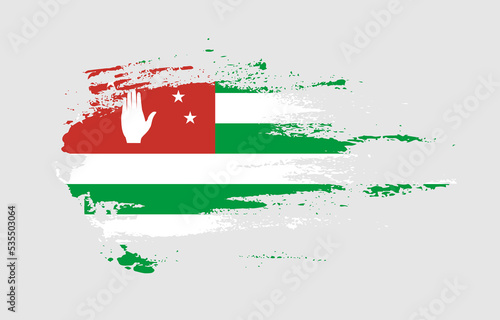 Grunge brush stroke flag of Abkhazia with painted brush splatter effect on solid background