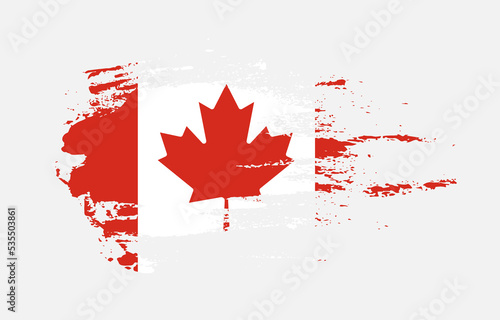 Grunge brush stroke flag of Canada with painted brush splatter effect on solid background