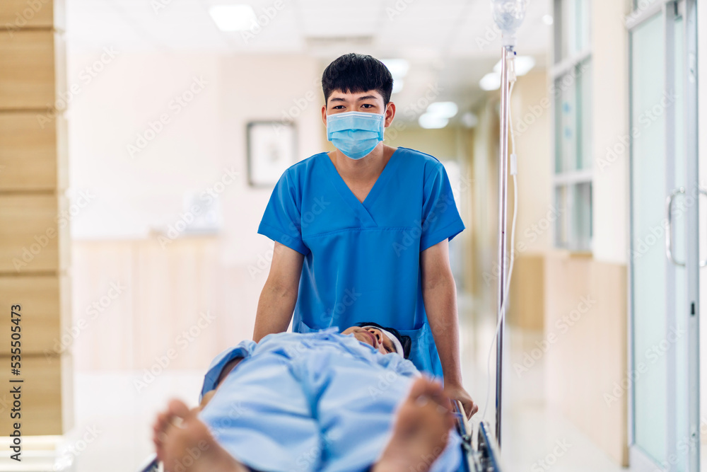 Group of professional medical doctor team and assistant with stethoscope in uniform taking seriously injured coma patient to operation emergency theatre room in hospital.health medical care concept. Group of professional medical doctor team and assistant with stethoscope in uniform taking seriously injured coma patient to operation emergency theatre room in hospital.health medical care concept.