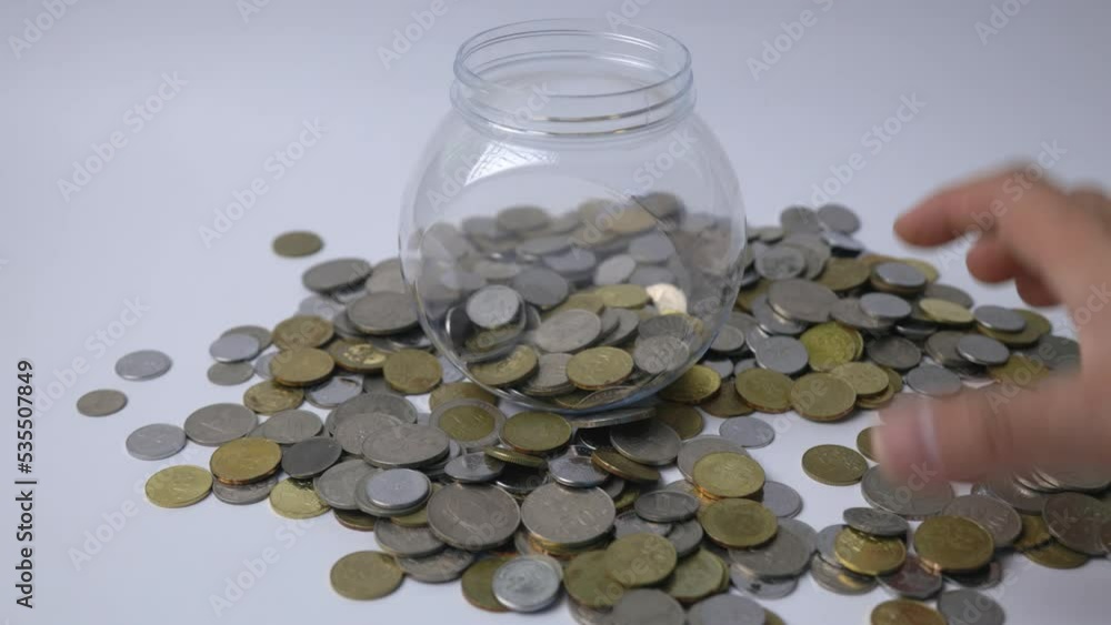 Man hand putting Malaysia currency coin on white background Man hand putting Malaysia currency coin on white background