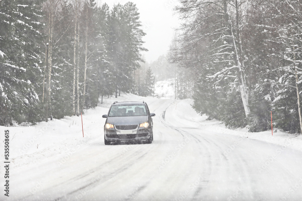 Car Driving along Icy Snowy Rural Road in Winter Snowfall. Car Driving along Icy Snowy Rural Road in Winter Snowfall.