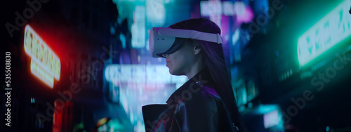 Photography CU Portrait of Hispanic female using her VR metaverse headset in the street full