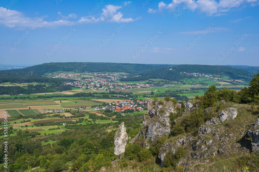 Obraz premium View from the summit of the Ehrenbürg on a rock formation below with a wide view of Franconian Switzerland/Germany