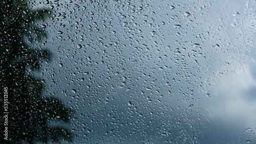raindrop flow on window cloudy background
