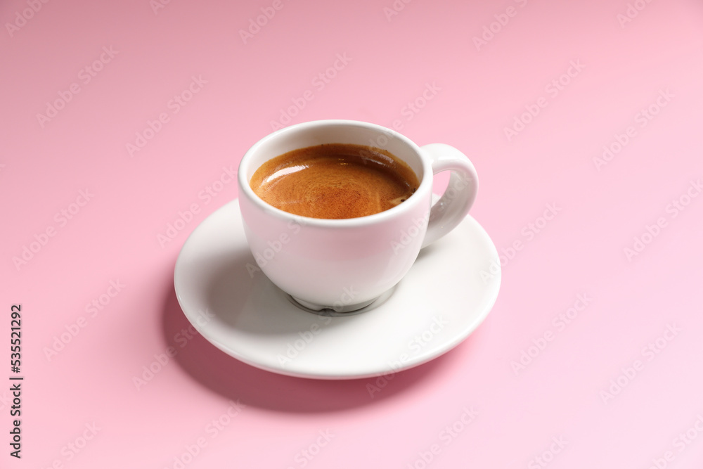 White cup of coffee espresso isolated on pink background White cup of coffee espresso isolated on pink background