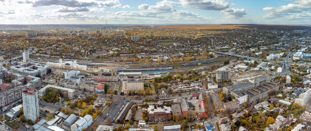 City aerial panorama view above Central Kharkiv railway station Pivdennyy Vokzal in autumn, downtown city streets rooftop in Kharkiv, Ukraine