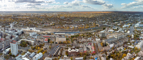City aerial panorama view above Central Kharkiv railway station Pivdennyy Vokzal in autumn, downtown city streets rooftop in Kharkiv, Ukraine