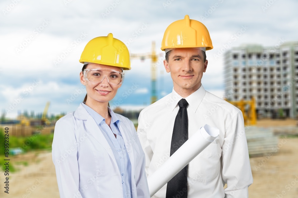 Professional engineer workers posing on the construction site Professional engineer workers posing on the construction site