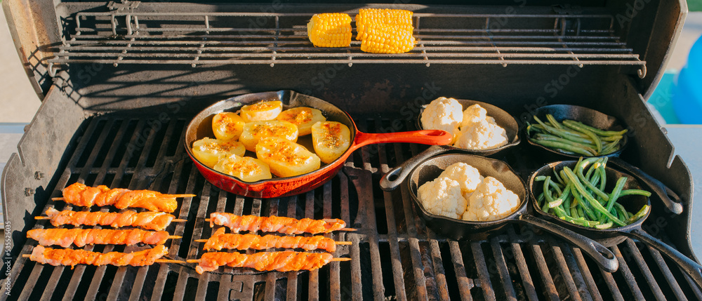 preparing dinner on a gas grill preparing dinner on a gas grill