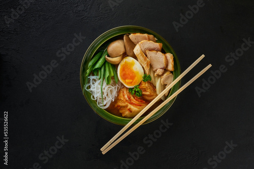 Photos Traditional Japanese soup with meat broth, asian rice noodles, sliced chiken, eggs