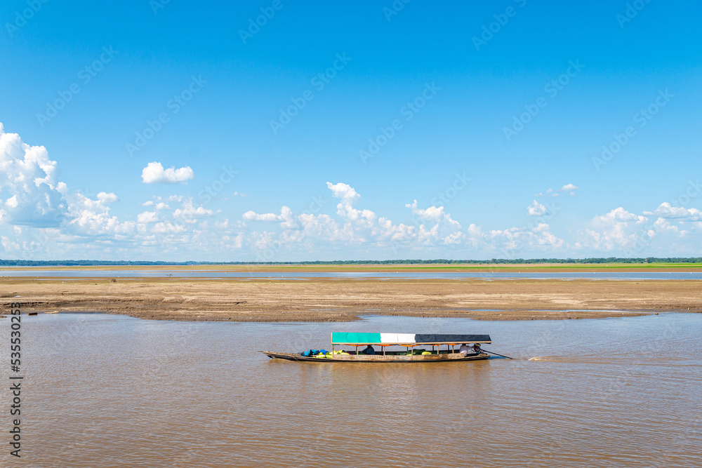 Fototapeta premium boat transporting food throught amazon river in peru