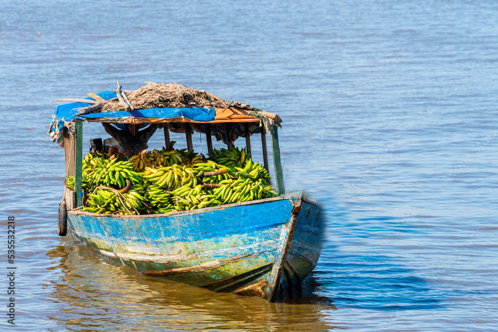 boat transporting food throught amazon river in peru