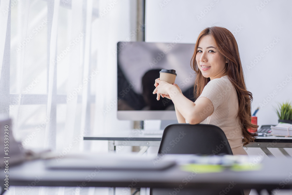 Portrait of Young Asian businesswoman is happy to work at the modern office using a laptop computer, freelance business employee online marketing e-commerce telemarketing concept. Portrait of Young Asian businesswoman is happy to work at the modern office using a laptop computer, freelance business employee online marketing e-commerce telemarketing concept.