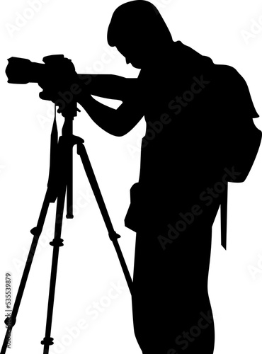 silhouette photographer wearing backpack taking a photo using a stand