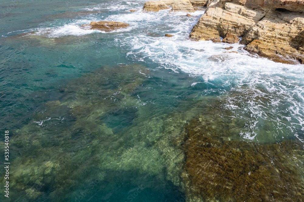 Mediterranean waves crash on the rocky shore in Cyprus