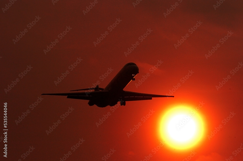 The plane will land when the sun sets on the western horizon