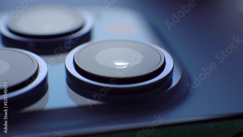 Blue three back side mobile photo camera lens. Close up slide movement. Digital technology, smartphone photography photo