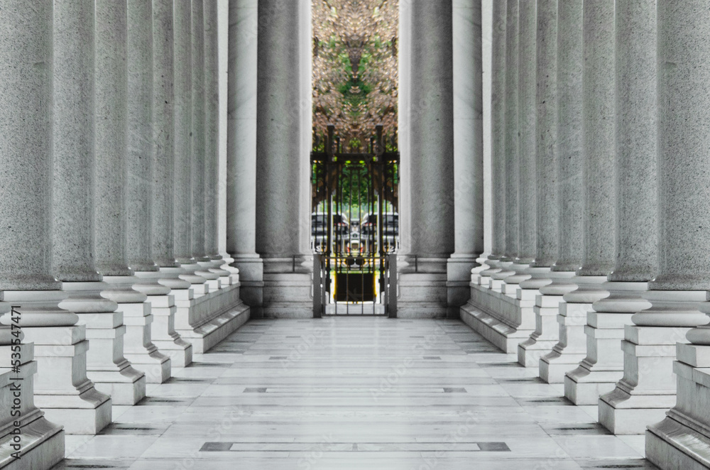 White marble pillars in a row. Row of marble columns. Stone columns.