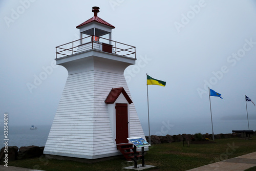 Lighthouse in the fog of Digby, Canada photo