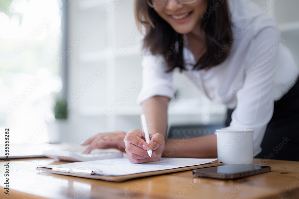 Business woman hand using calculator to calculate the company's financial results and budget. Account Audit Concept Business woman hand using calculator to calculate the company's financial results and budget. Account Audit Concept