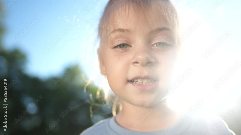 little girl portrait in the park. close-up a girl child in nature. happy family kid concept. happy girl smiling sunlight. cheerful little girl portrait close-up. child outdoors nature in the park little girl portrait in the park. close-up a girl child in nature. happy family kid concept. happy girl smiling sunlight. cheerful little girl portrait close-up. child outdoors nature in the park