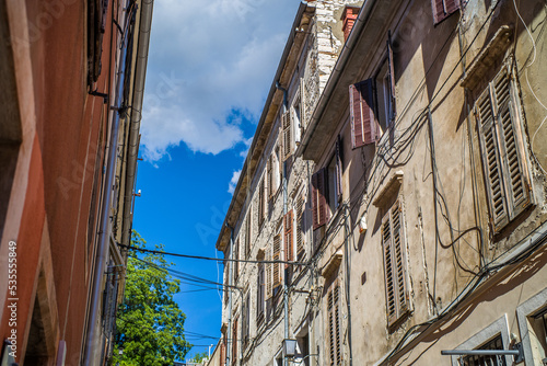 old  colorful houses and narrow streets in the center of the old town of Pula. In the background  port oddities
