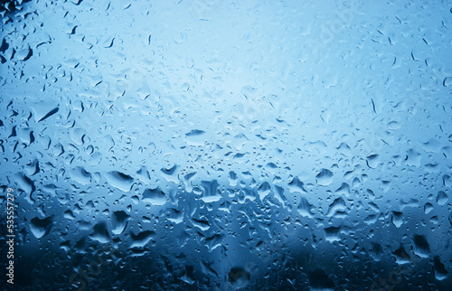 Raindrops on glass window texture backdrop