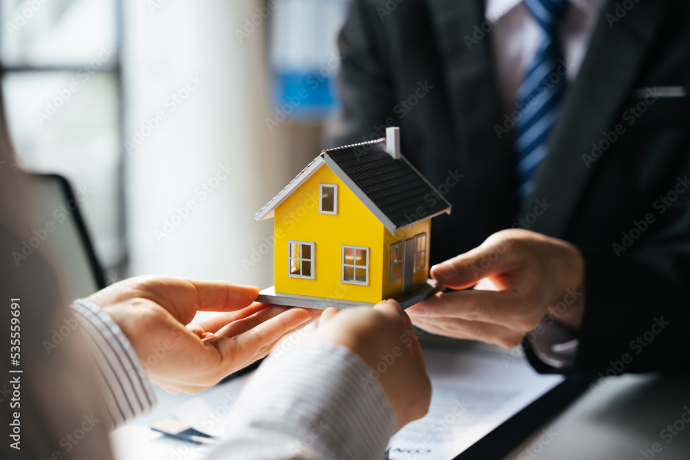 Real estate agent offer hand for customer sign agreement contract signature for buy or sell house. Real estate agent offer hand for customer sign agreement contract signature for buy or sell house.