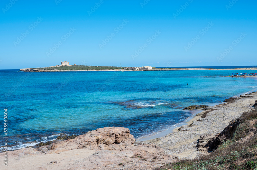 the beautiful sea of Portopalo with transparent and turquoise water with the island of Capo Passero in the background