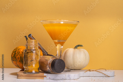 Halloween, Thanksgiving or fall cocktail pumpkintini cocktail. Sweet pumpkin martini, festive seasonal drink with cinnamon and pumpkin pie spices photo