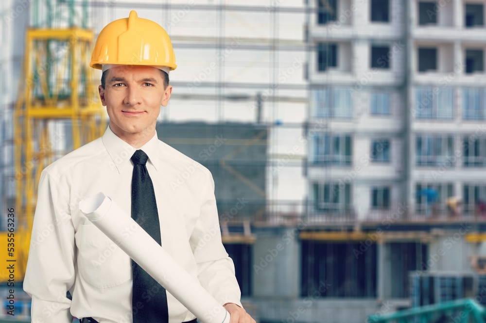 Young male builder working with construction cite background Young male builder working with construction cite background