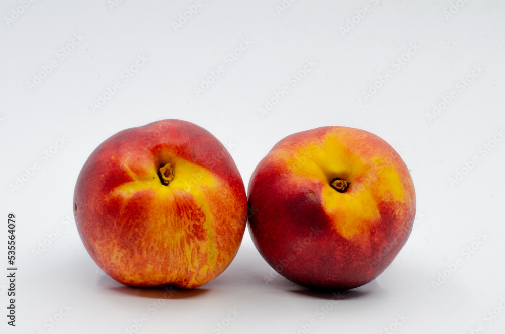 Red colored nectarines. Red nectarine fruit isolated on white background.
Red colored nectarines. Red nectarine fruit isolated on white background.