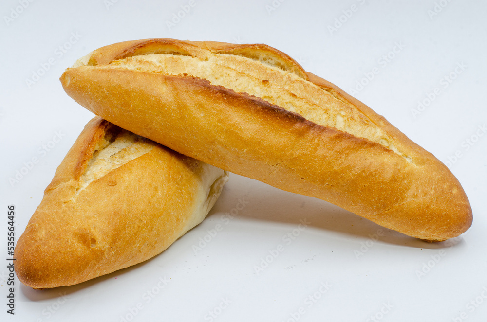 Hot breads out of the oven. Loaf of bread on a white isolated background. The staple food is bread.
