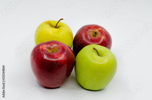 Red and Green colored Apples in a blue colored plate. Red and green apples isolated on a white background.
