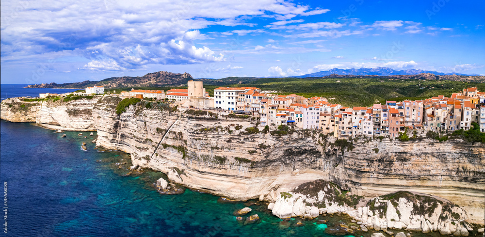 Bonifacio - splendid coastal town  in south of Corsica island, aerial drone view of houses hanging over rocks. France