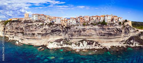 Bonifacio - splendid coastal town in south of Corsica island, aerial drone view of houses hanging over rocks. France