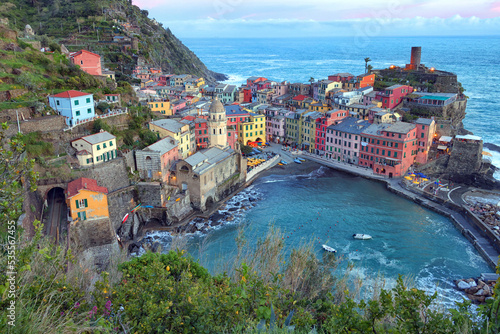 Fantastic panorama of Vernazza, amazing colorful medieval buildings and fishing boats in harbor at sunset, Cinque Terre National Park, Liguria, Italy, Europe