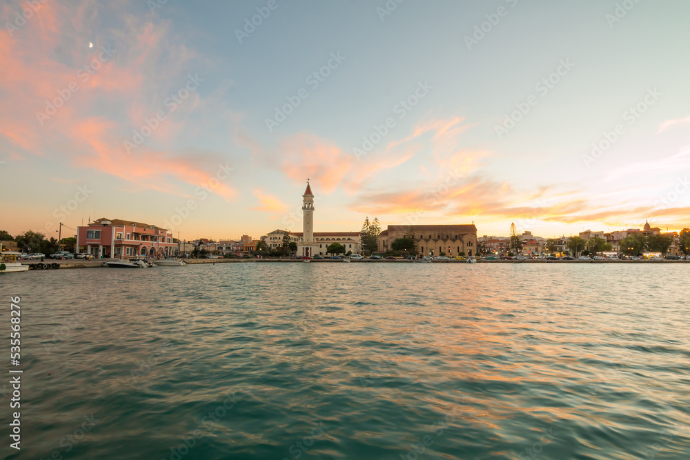 View on town hall and Saint Dionysios Church, Ionian Sea, Zakynthos island, Greece, Europe. Amazing sunset view. Zakynthos tower in the evening lights. The main harbor of the city. 