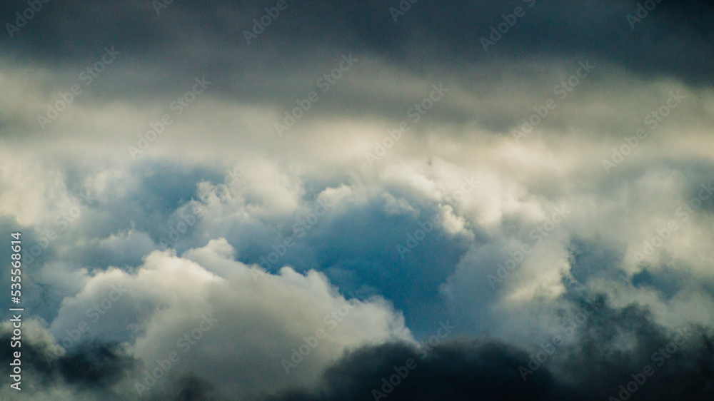 Fototapeta premium Cluster of dark blue and grey storm clouds 