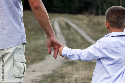 A Happy child and parent's hands on nature in the park travel